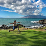 David doing a lunge by the ocean.