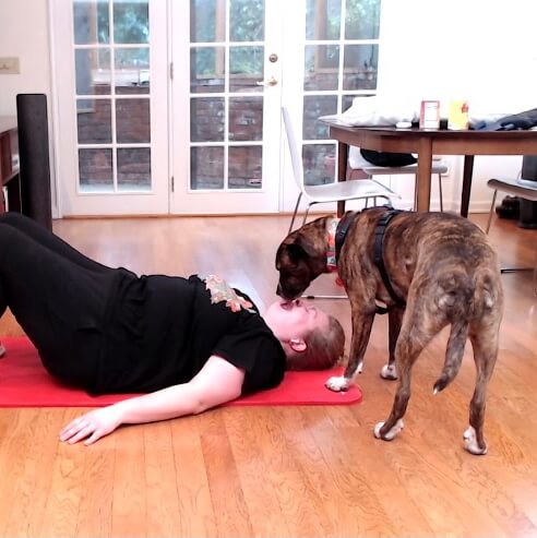 dog licking human's face during crunches